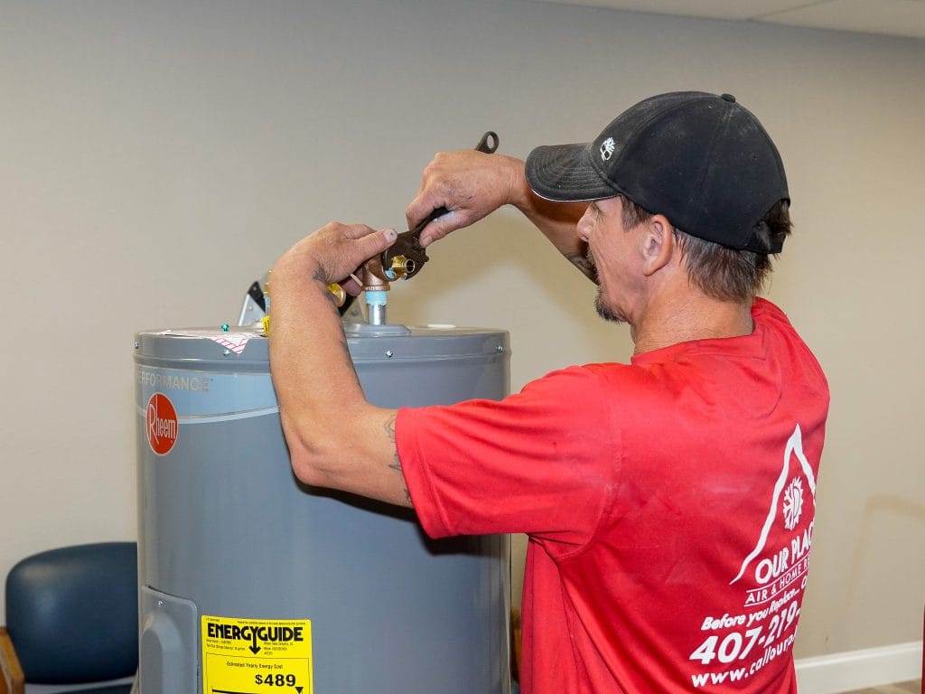 Certified Our Place plumber installing an expansion tank on a water heater